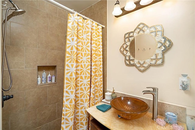 bathroom featuring vanity and curtained shower