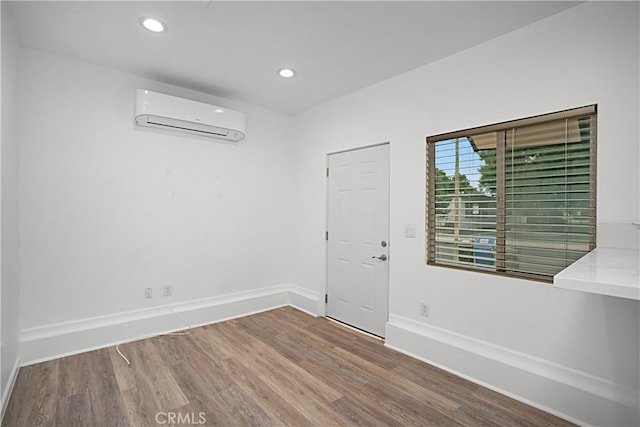 entryway with hardwood / wood-style flooring and a wall mounted air conditioner