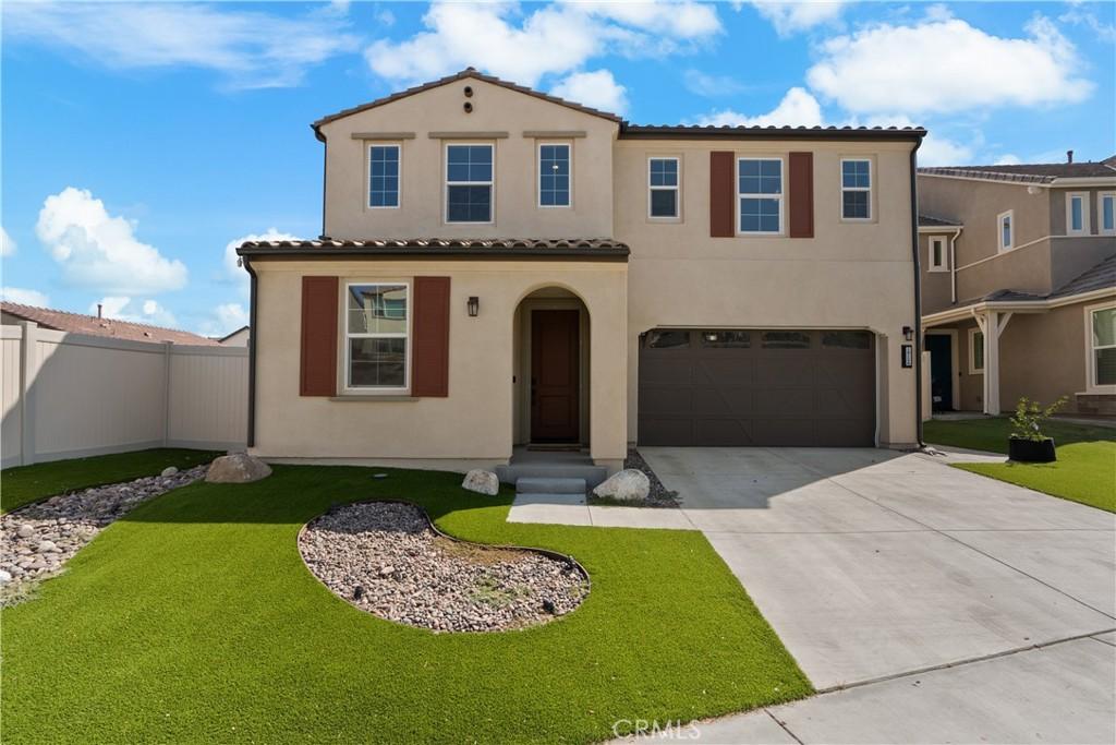 mediterranean / spanish-style house featuring a front lawn and a garage