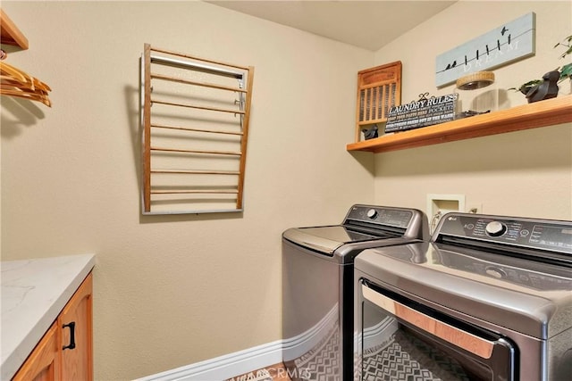 laundry area featuring cabinets and washer and clothes dryer