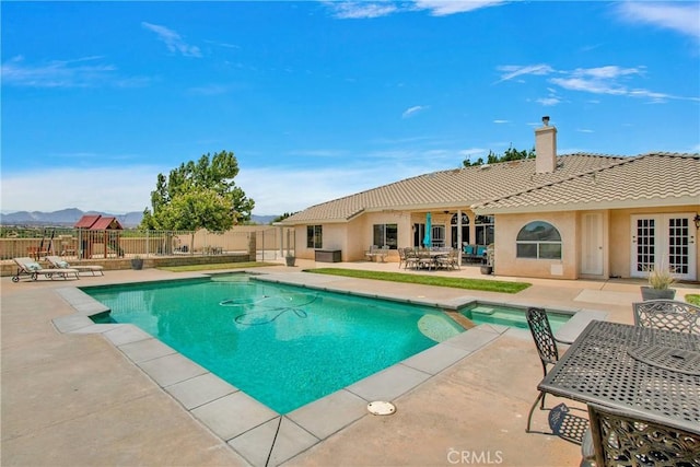 view of swimming pool featuring a mountain view and a patio