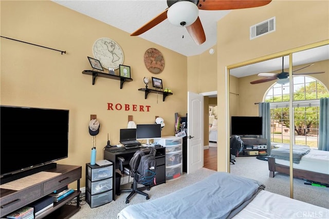 carpeted bedroom featuring a closet and ceiling fan