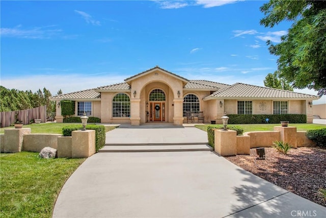 mediterranean / spanish-style house with a front lawn