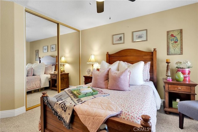 bedroom featuring ceiling fan, a closet, and light carpet