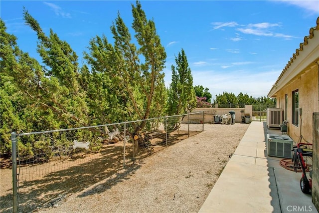 view of yard featuring a patio and central AC