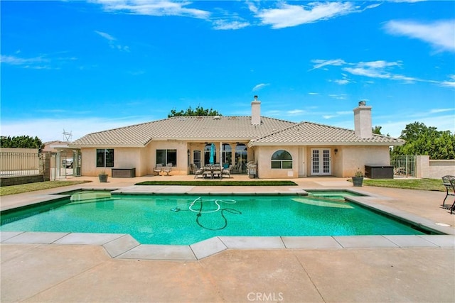 view of pool with central air condition unit, an in ground hot tub, a patio, and french doors