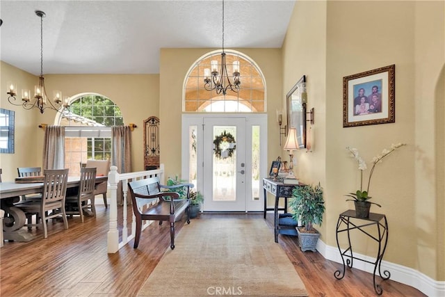 entryway featuring hardwood / wood-style flooring and a notable chandelier