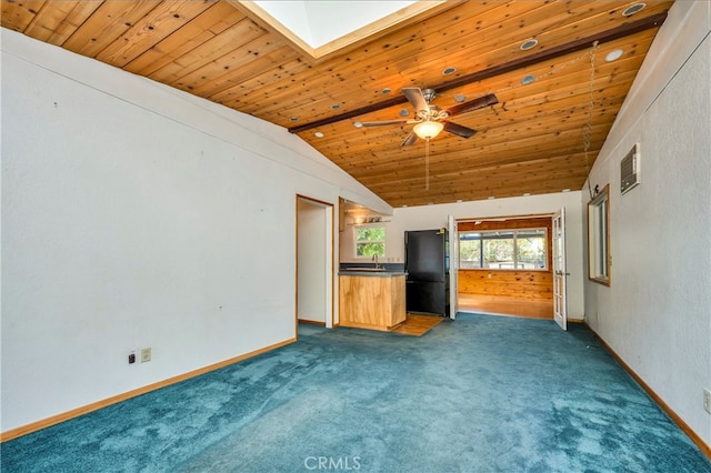 unfurnished living room with vaulted ceiling with skylight, dark colored carpet, and wooden ceiling