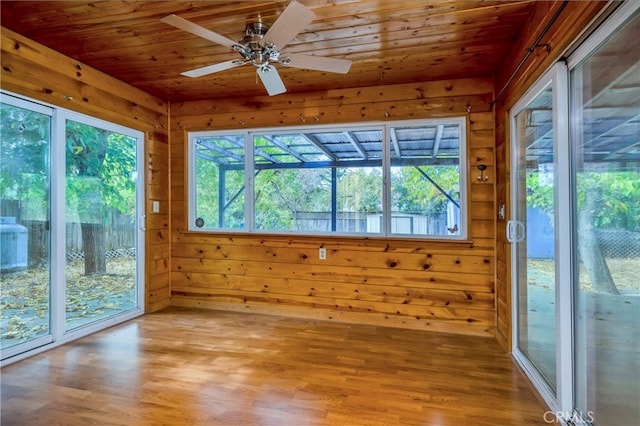 unfurnished sunroom featuring ceiling fan and wooden ceiling