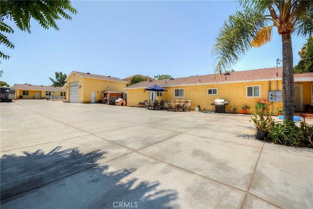 back of property featuring a patio and a garage