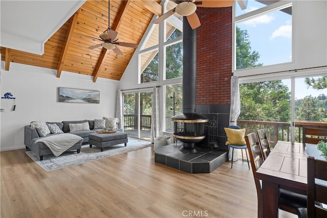 living room featuring light hardwood / wood-style floors, ceiling fan, and a healthy amount of sunlight