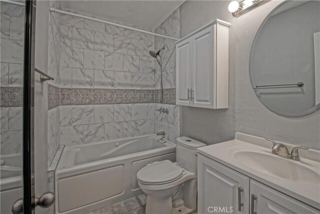 full bathroom featuring vanity, toilet, and tiled shower / bath