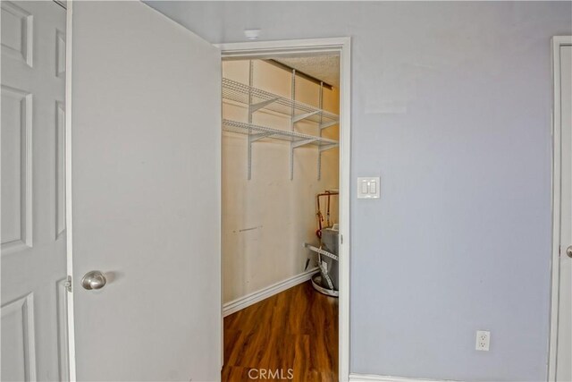 1108 Camino Real Unit 510, Redondo Beach, CA 90277 - laundry room featuring wood finished floors and baseboards