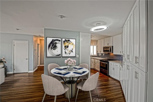 1108 Camino Real Unit 510, Redondo Beach, CA 90277 - dining space with dark wood-style flooring and baseboards