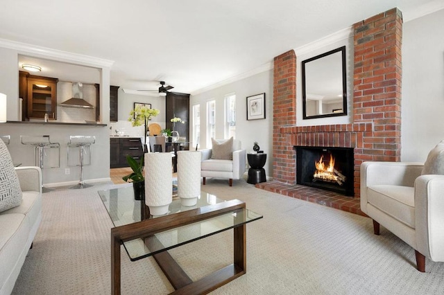 living room featuring ceiling fan, light carpet, crown molding, and a fireplace