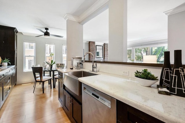 kitchen featuring dishwasher, ceiling fan, sink, light stone counters, and ornamental molding