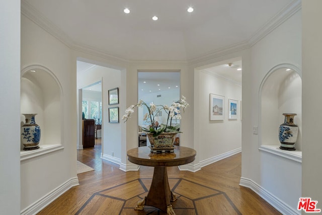 entrance foyer with crown molding and hardwood / wood-style floors