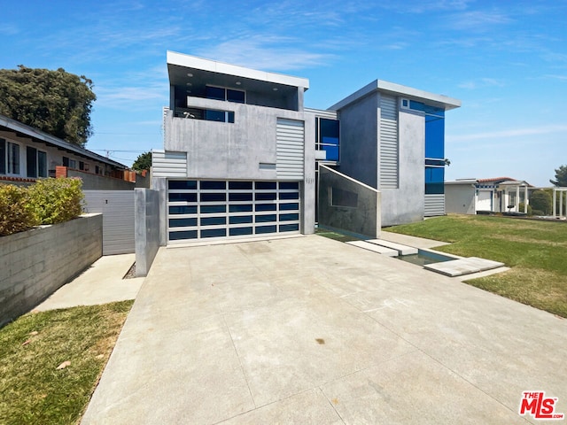 contemporary house with a front yard and a garage