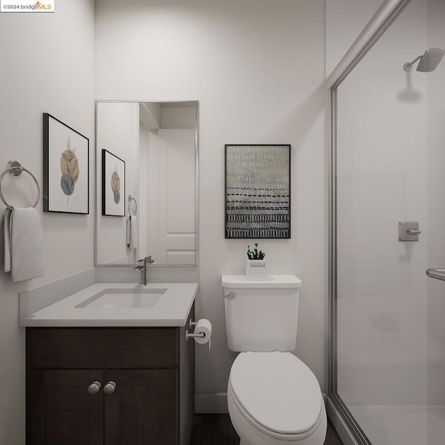 bathroom with vanity, toilet, and a shower with shower door