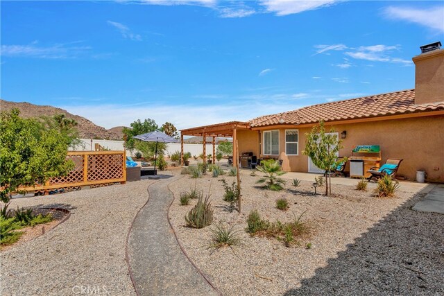 exterior space with a mountain view and a patio