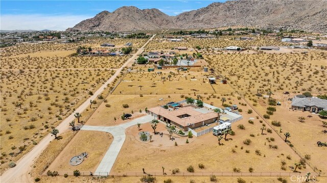 drone / aerial view with a mountain view and a rural view