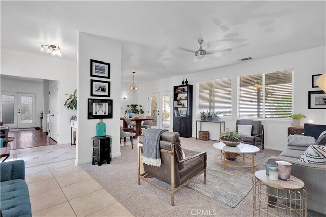 living room with ceiling fan, light tile patterned floors, and french doors