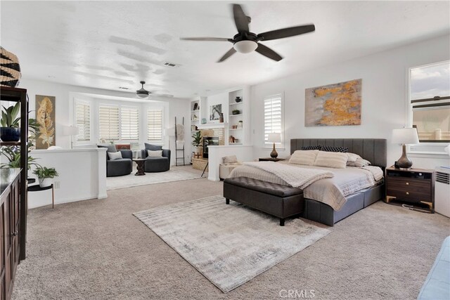 bedroom with ceiling fan and light carpet