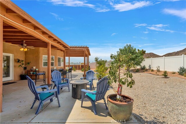 view of patio featuring a fire pit, ceiling fan, and a pergola