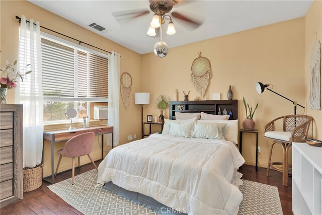 bedroom with ceiling fan and dark hardwood / wood-style floors