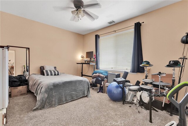 bedroom with ceiling fan and light colored carpet