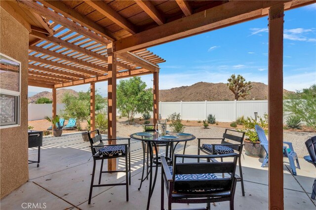 view of patio featuring a mountain view and a pergola