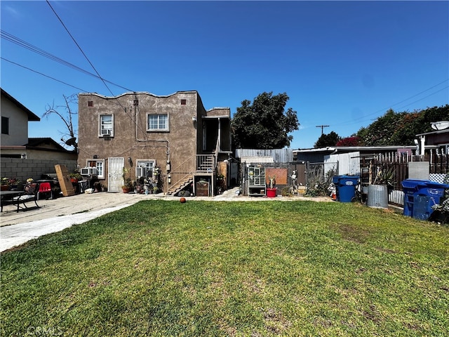 rear view of property with a lawn