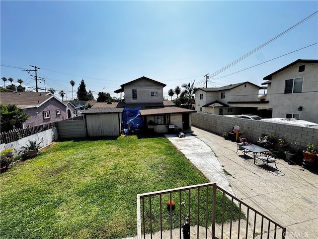 view of yard with a shed and a patio area