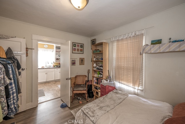 bedroom with sink and light wood-type flooring