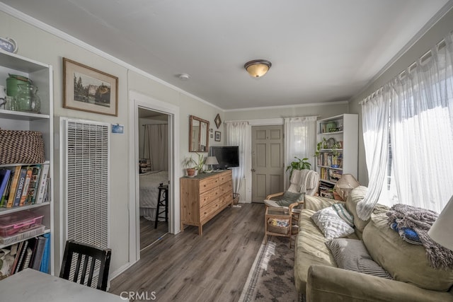 living room featuring dark hardwood / wood-style flooring and ornamental molding