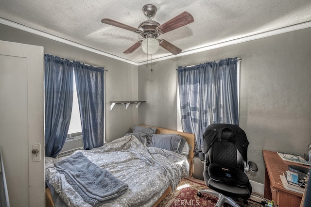 bedroom with a textured ceiling and ceiling fan