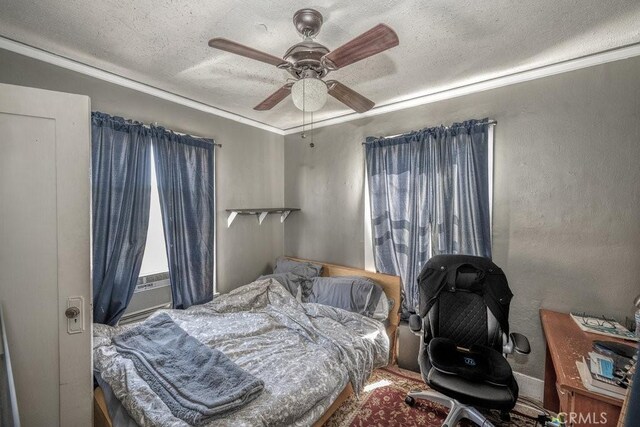 bedroom with a ceiling fan, a textured ceiling, and cooling unit