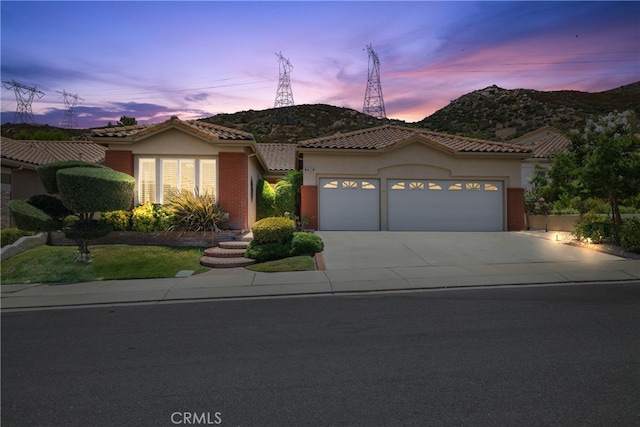 view of front of property featuring a mountain view and a garage