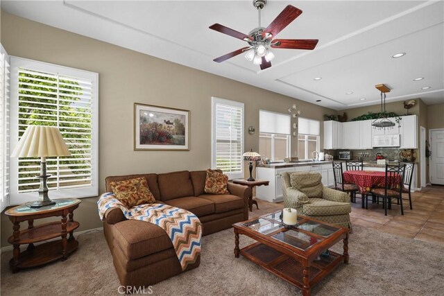 tiled living room featuring a healthy amount of sunlight and ceiling fan