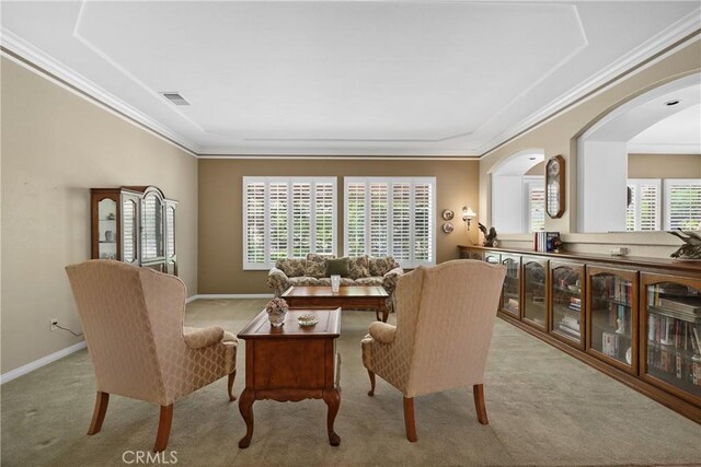 carpeted dining space featuring ornamental molding