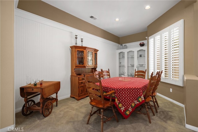 dining area featuring light carpet