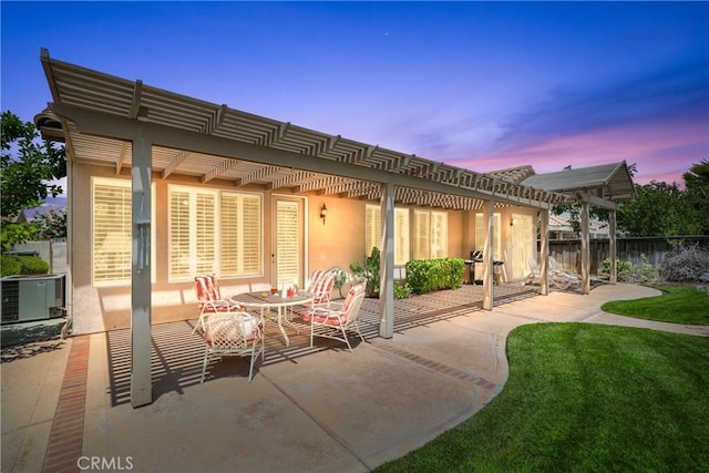 back of house with a patio, fence, a yard, a pergola, and stucco siding