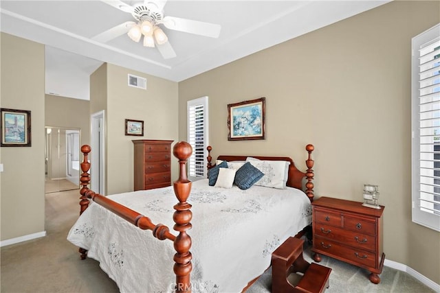 bedroom featuring light carpet, baseboards, visible vents, a ceiling fan, and vaulted ceiling