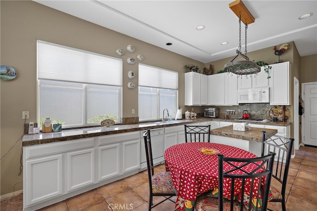 kitchen with light tile patterned floors, white cabinets, decorative backsplash, and white appliances