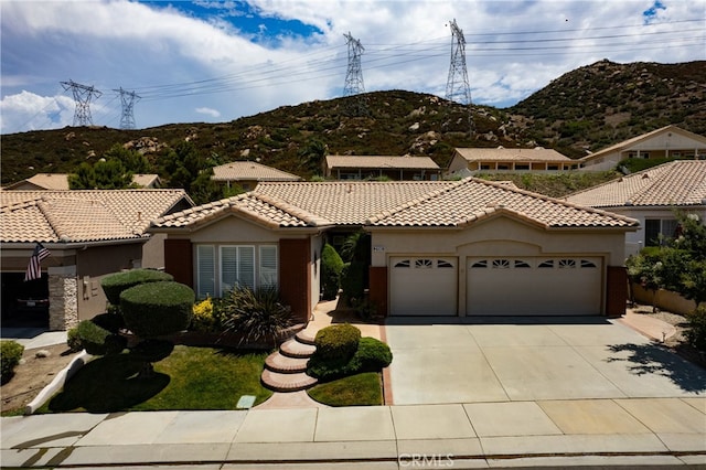 mediterranean / spanish-style house featuring a mountain view and a garage