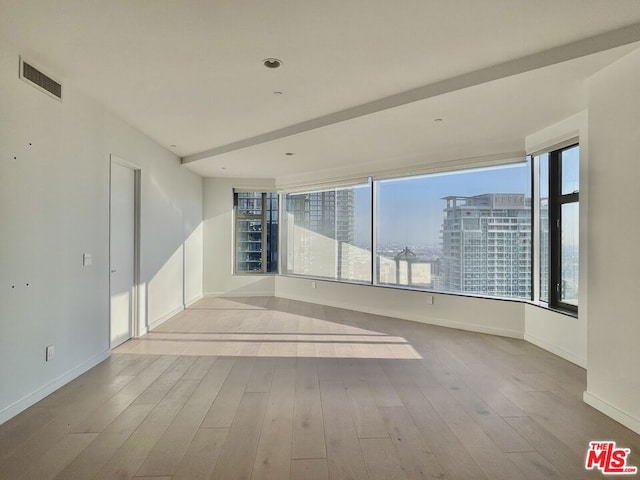 spare room featuring light hardwood / wood-style floors