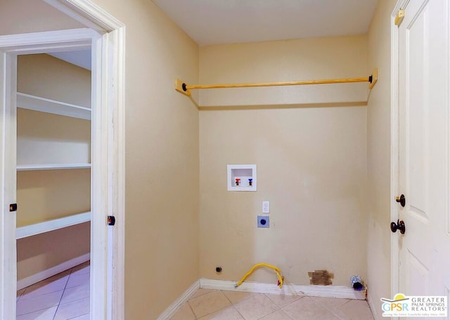 clothes washing area featuring washer hookup, light tile patterned floors, hookup for an electric dryer, and hookup for a gas dryer