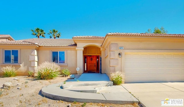 mediterranean / spanish-style home with a garage