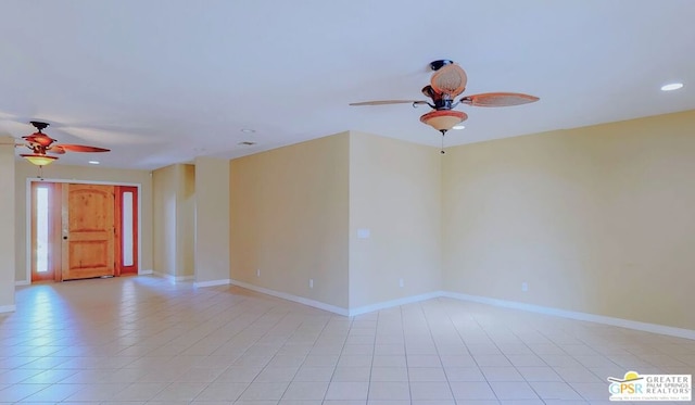 spare room featuring light tile patterned floors and ceiling fan