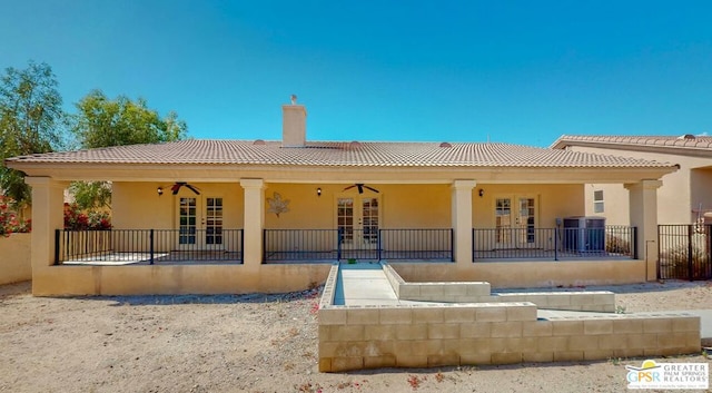 rear view of house with central AC and french doors